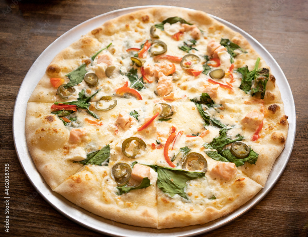 Pizza is on the plate on the wooden table Pizza is on the plate on the wooden table