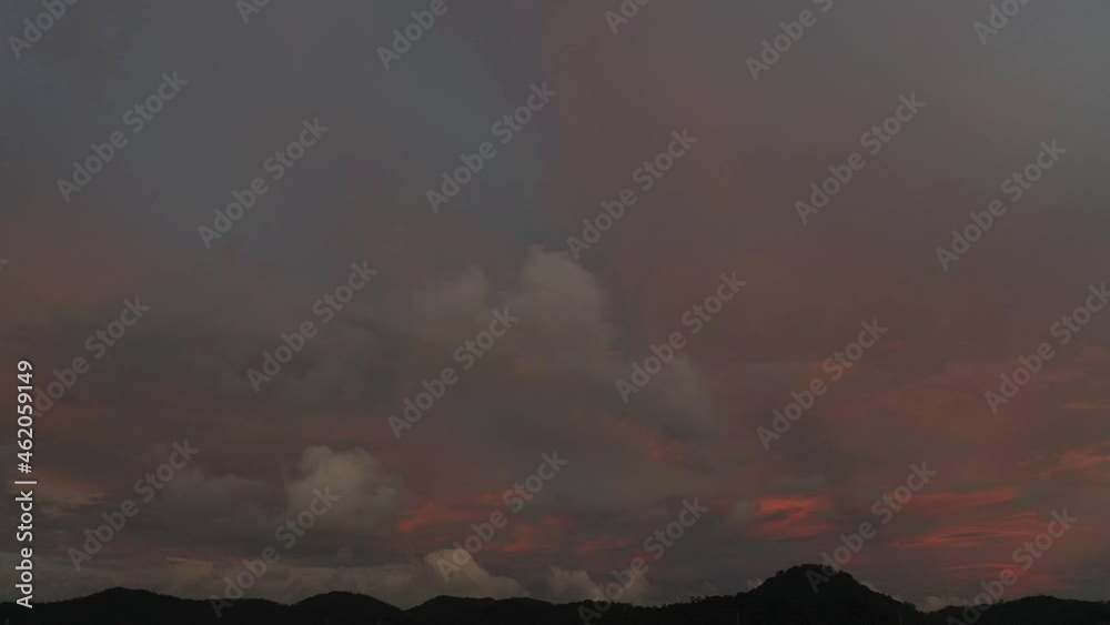 Scene of Colorful romantic red sky sunset with Changing the color of the sky background. .beautiful large red cloud at sunset above Phuket city..beautiful red sky at sunset nature and travel concept