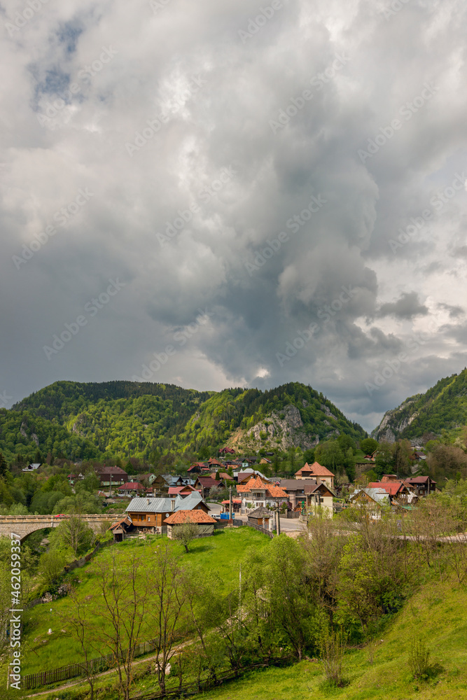 Ancient village among the Romanian Carpathian mountains with a storm about to fall on the ground