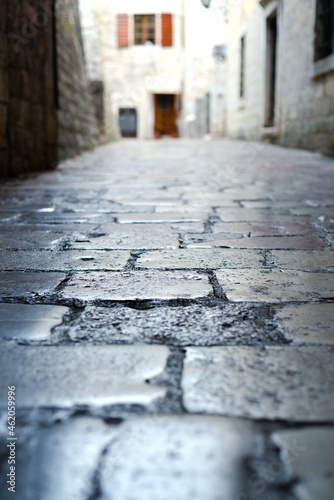 Narrow cobblestone street in the old town. Kotor, Montenegro. Close-up. Selective focus.