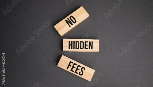 NO HIDDEN FEES words on wooden blocks on yellow background. Business ethics concept.