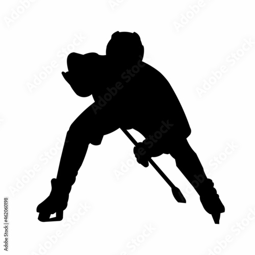 Silhouette of a hockey team player in front who bent down to hit the puck