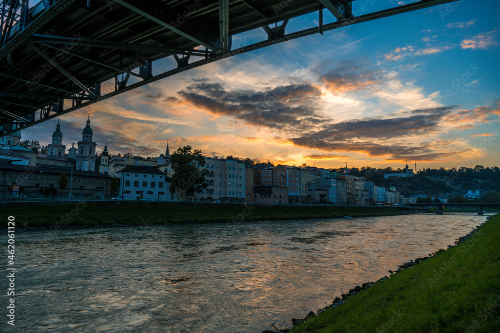 Mozartsteg in the city of salzburg at sunset with clouds over river salzach
