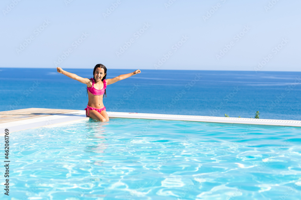 Young girl posing near swimming pool