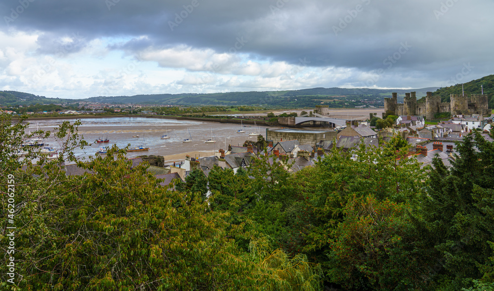 view to the well preserved and imposing fortress of the 13th century medieval Conwy castle and estuary, seen from the Western town wall