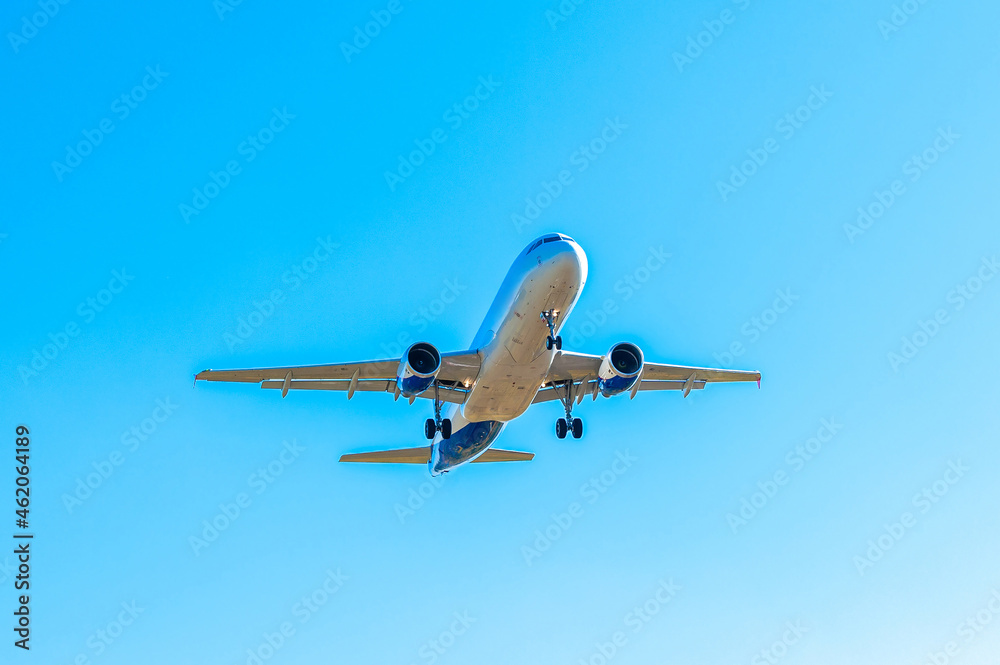 The passenger plane is landing on the runway, landing at the international airport. Air transportation, air travel. Clear cloudless sky. Vacation flights. The passenger plane is landing on the runway, landing at the international airport. Air transportation, air travel. Clear cloudless sky. Vacation flights.