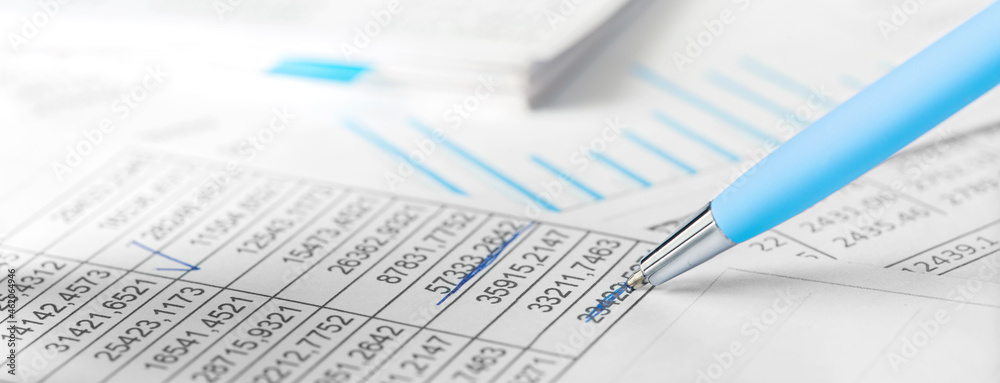 Accounting document with pen,color diagram and checking financial chart. Concept of banking, financial report and financial audit. In blue color. Accounting document with pen,color diagram and checking financial chart. Concept of banking, financial report and financial audit. In blue color.