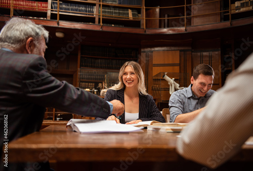 Students preparing exam and learning lessons in school library
