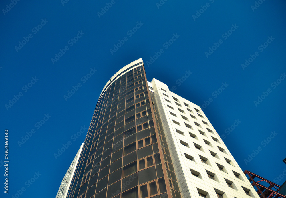 Unfinished high-rise building against a bright blue sky