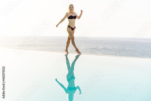Lifestyle summer vacation concept  Women in swimsuit relax on the pool  young sexy woman in bikini near the pool. Summer holidays  travel  people and vacation concep