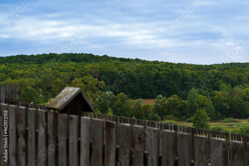 Wildlife view of the village above the rustic wood fence