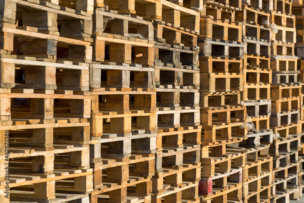 Warehouse concept. Many wooden pallets as a background