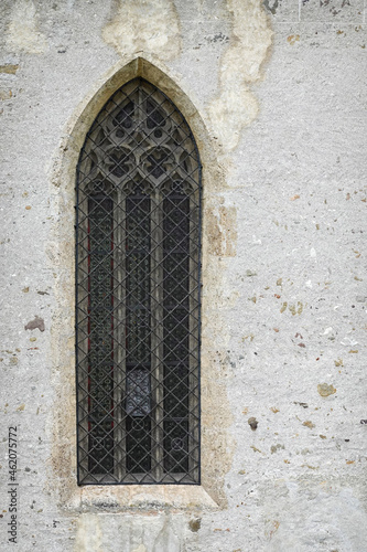 Window with stained glass windows on the old church. High arched window in the Church of Fiera di Primiero, Italy, Europe  © Rechitan Sorin