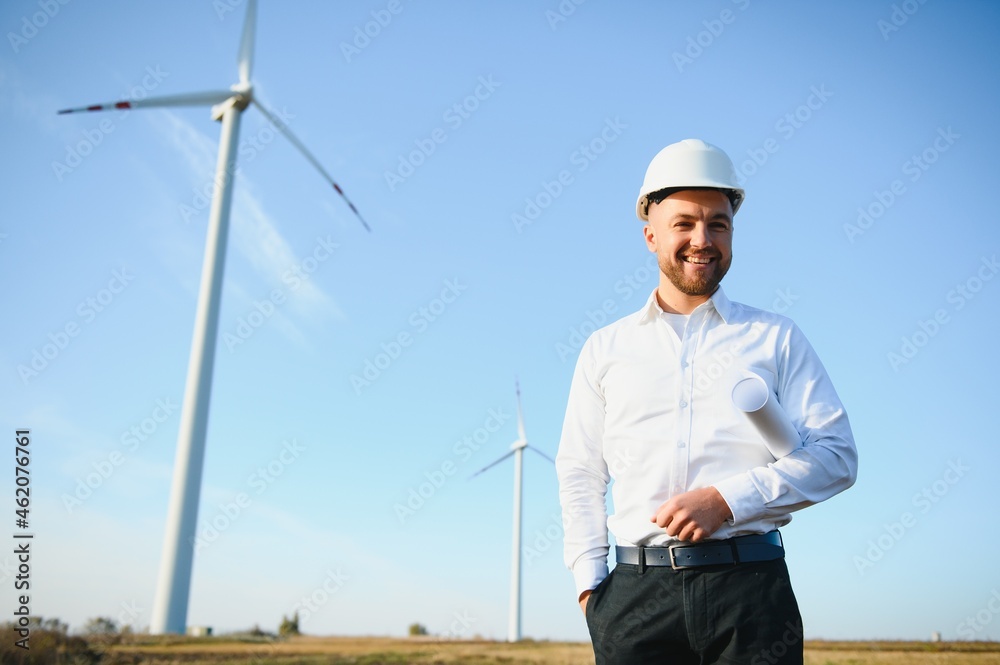 Businessmen engineering standing handsome smile front of turbine looking away