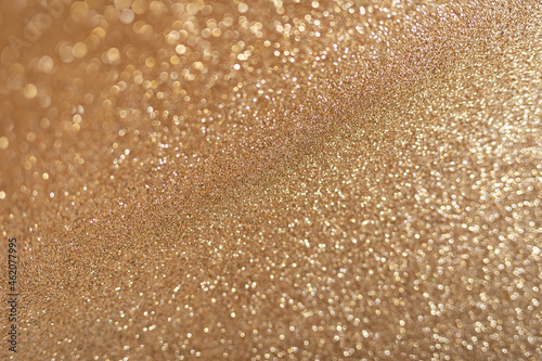 Golden glitter background with small particles