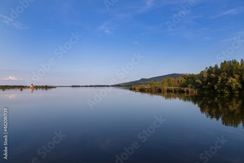 Nove mlyny reservoir and in the background the flooded church of St. Linhart and Palava with the ruins Divci Hrady in the Czech Republic. © Roman Bjuty