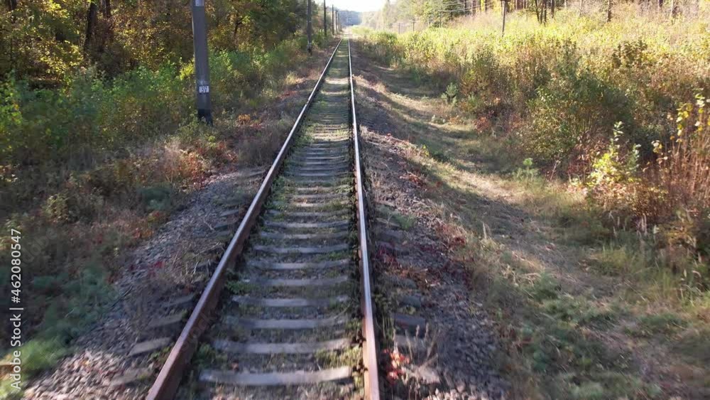 Flight over the train tracks near forest on an autumn sunny day, Ukraine. Travel and nature concept Flight over the train tracks near forest on an autumn sunny day, Ukraine. Travel and nature concept
