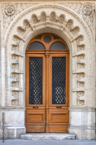 Paris, an ancient door, typical building in the 11e arrondissement 