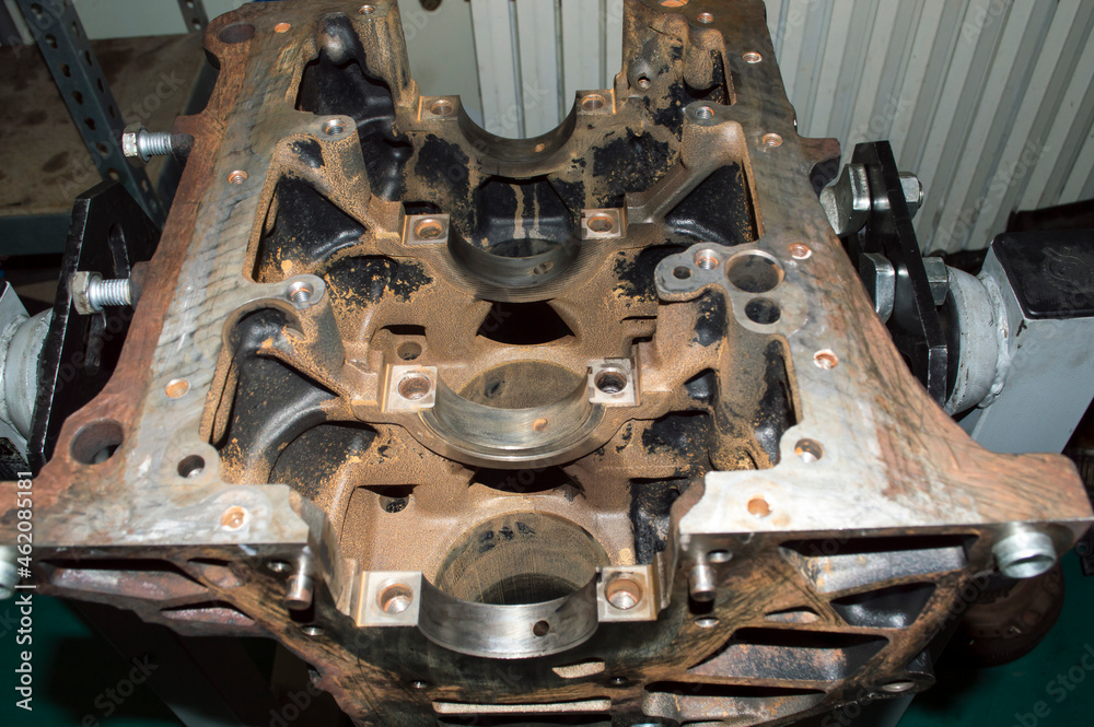 View of the lower part of the old engine cylinder block mounted on the engine repair stand