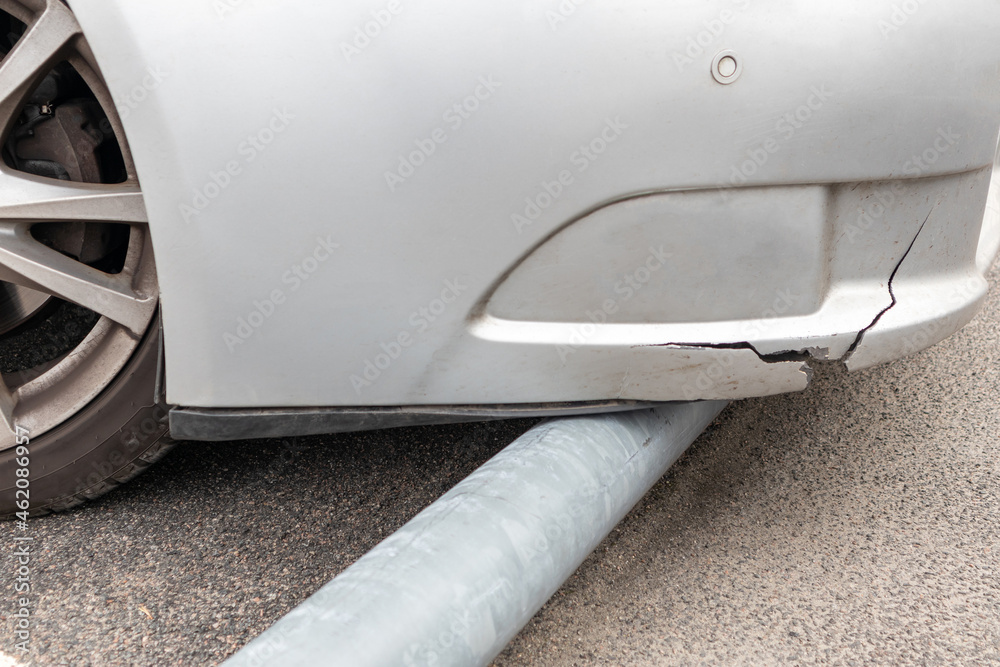 Torn car bumper crashing into the parking curb Stock Photo | Adobe Stock