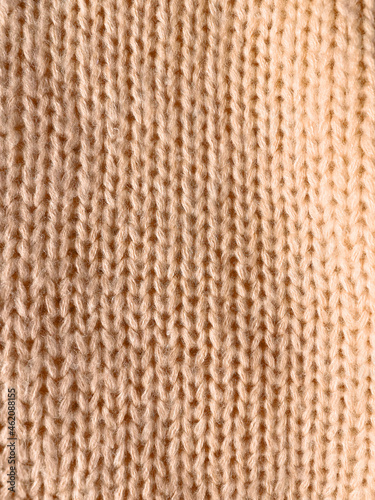 beige knitted background. pigtail texture