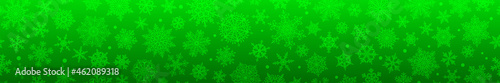 Christmas horizontal banner of big and small complex snowflakes with seamless horizontal repetition, in green colors. Winter background with falling snow