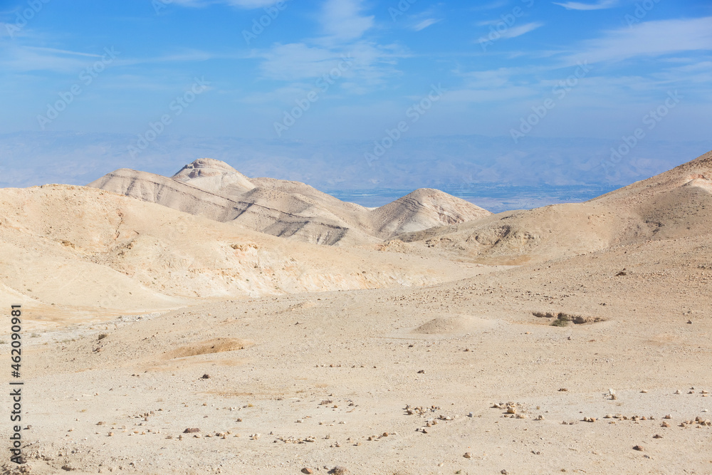 Judean Desert in clear weather, Israel. White sand dunes and blue sky. Wadi Qelt land. Stony desert in the heat