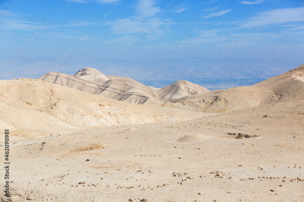 Judean Desert in clear weather, Israel. White sand dunes and blue sky. Wadi Qelt land. Stony desert in the heat Judean Desert in clear weather, Israel. White sand dunes and blue sky. Wadi Qelt land. Stony desert in the heat