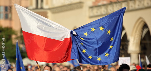 Fotografie, Obraz European union flag tied together with flag of Poland during street demonstratio