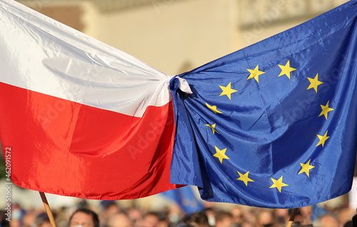European union flag tied with flag of Poland on public street demonstration to support Poland as membership of EU