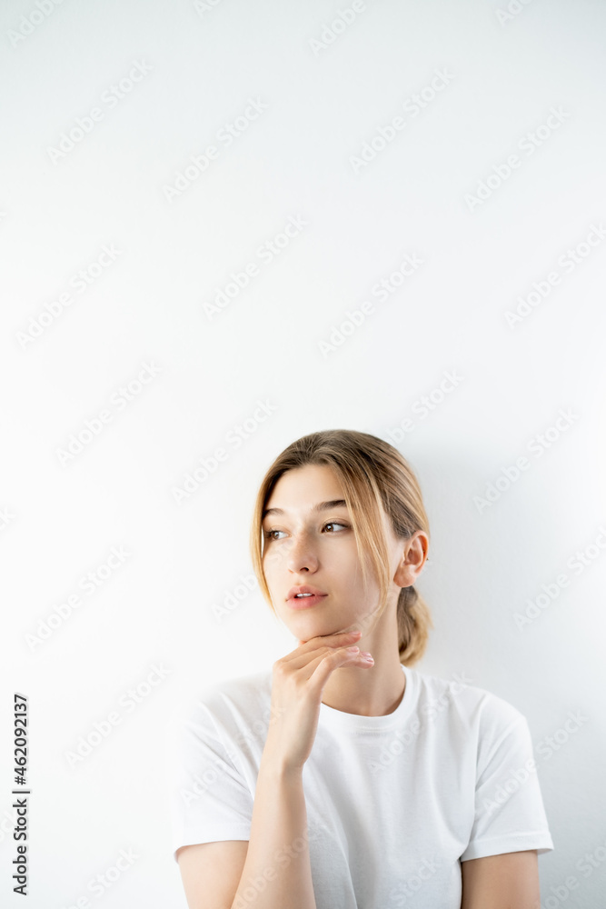 Skincare model. Beauty service. Cosmetic treatment. Gorgeous thoughtful young woman with perfect smooth face isolated on white copy space background. Skincare model. Beauty service. Cosmetic treatment. Gorgeous thoughtful young woman with perfect smooth face isolated on white copy space background.