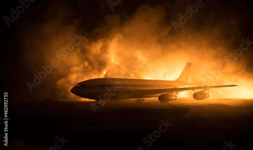 Air Crash. Burning falling plane. The plane crashed to the ground. Decorated with toy at dark fire background. Air accident concept.