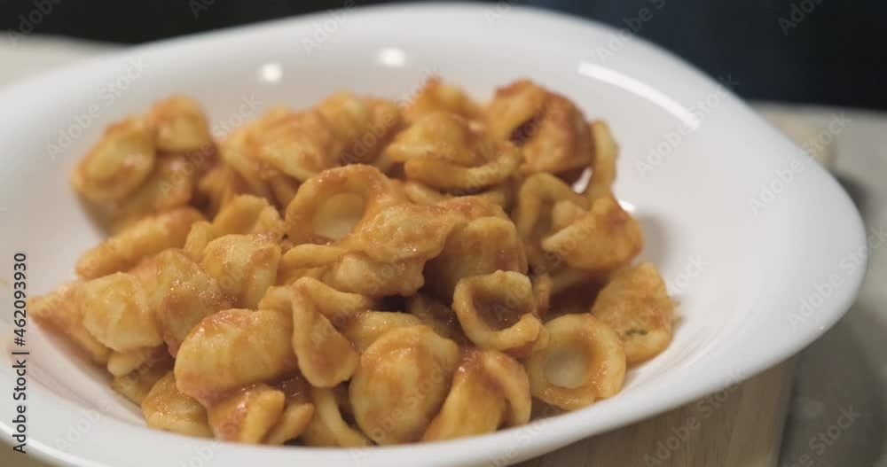 The first course of orecchiette with sauce, a typical Apulian dish. Typical Italian cuisine The first course of orecchiette with sauce, a typical Apulian dish. Typical Italian cuisine