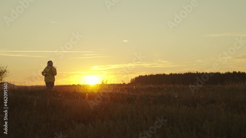 girl runs at sunset, silhouette of woman preparing for running competition, doing sports in nature outdoors, keeping an eye on her figure and health, living in body movement, morning jogging at dawn