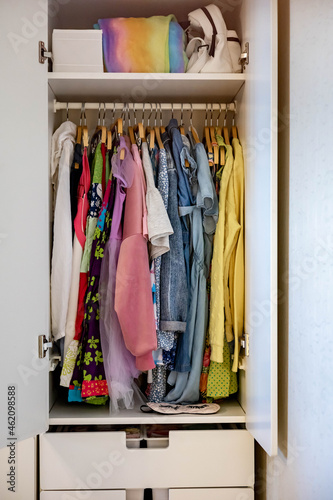 Wardrobe with perfect order clothes shades. Storage clothes. Teenager girl clothes.