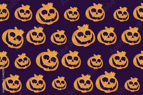 Seamless Halloween pattern. Pumpkin face on a dark purple background. Flat lay