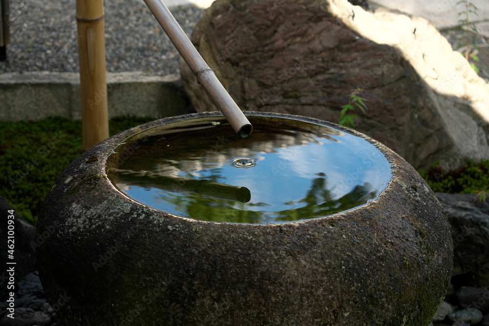 Kyoto,Japan - October 6, 2021: Dropping water in Chozubachi or washbasin or stoup or font for cleaning hands
Kyoto,Japan - October 6, 2021: Dropping water in Chozubachi or washbasin or stoup or font for cleaning hands
