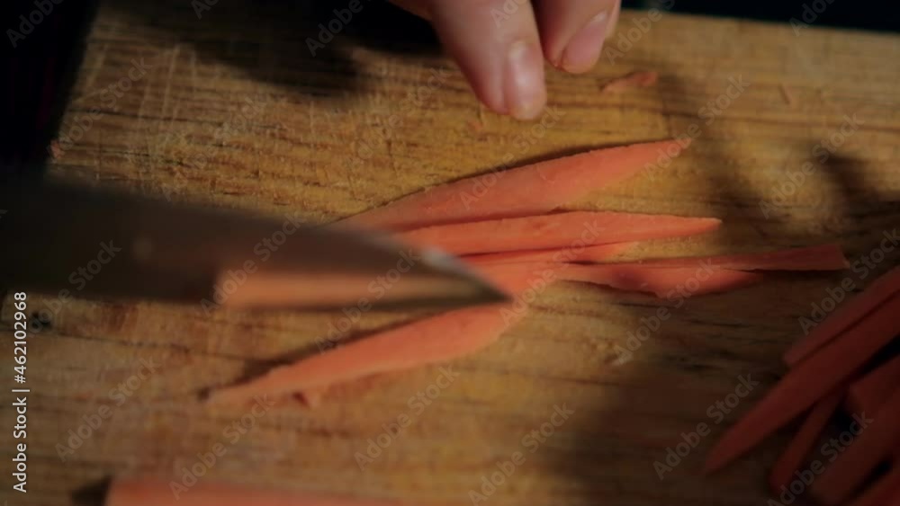 Hands cutting yam slices on a cutting board Hands cutting yam slices on a cutting board