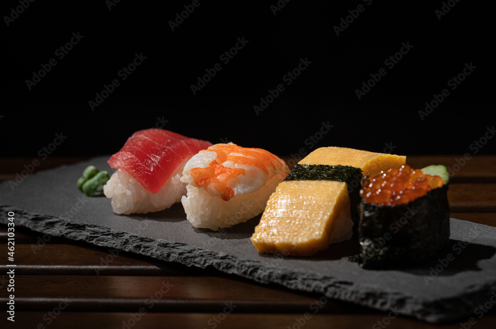 japanese sushi(tuna,egg,shrimp,caviar) and green bud on plate with minimal style japanese sushi(tuna,egg,shrimp,caviar) and green bud on plate with minimal style