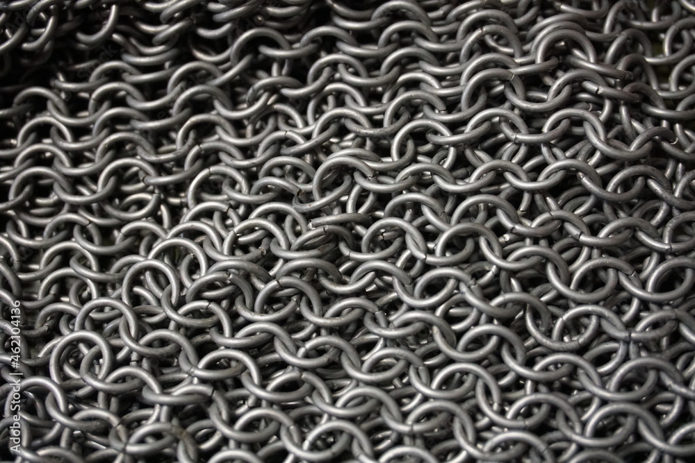 Ring armor - armor woven from iron rings, a metal net to protect against being hit by melee weapons. chain mail, shell. blacksmith product, close-up, background Ring armor - armor woven from iron rings, a metal net to protect against being hit by melee weapons. chain mail, shell. blacksmith product, close-up, background