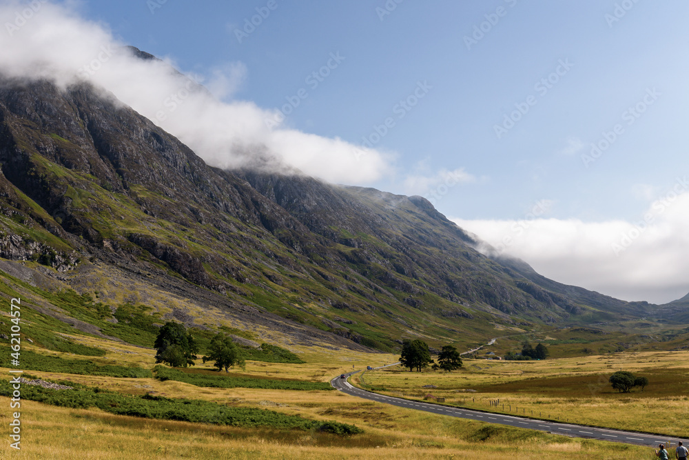 Clouds hanging over the mountain peaks in the beautiful Glencoe valley in the highlands of Scotland