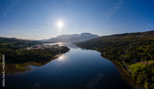 Aerial view of the sun rising above Fort William and the Ben Nevis mountain range in the Scottish Highlands photo