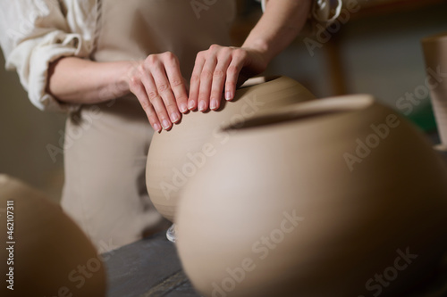 Picture of potters hands molding a shape of a pot