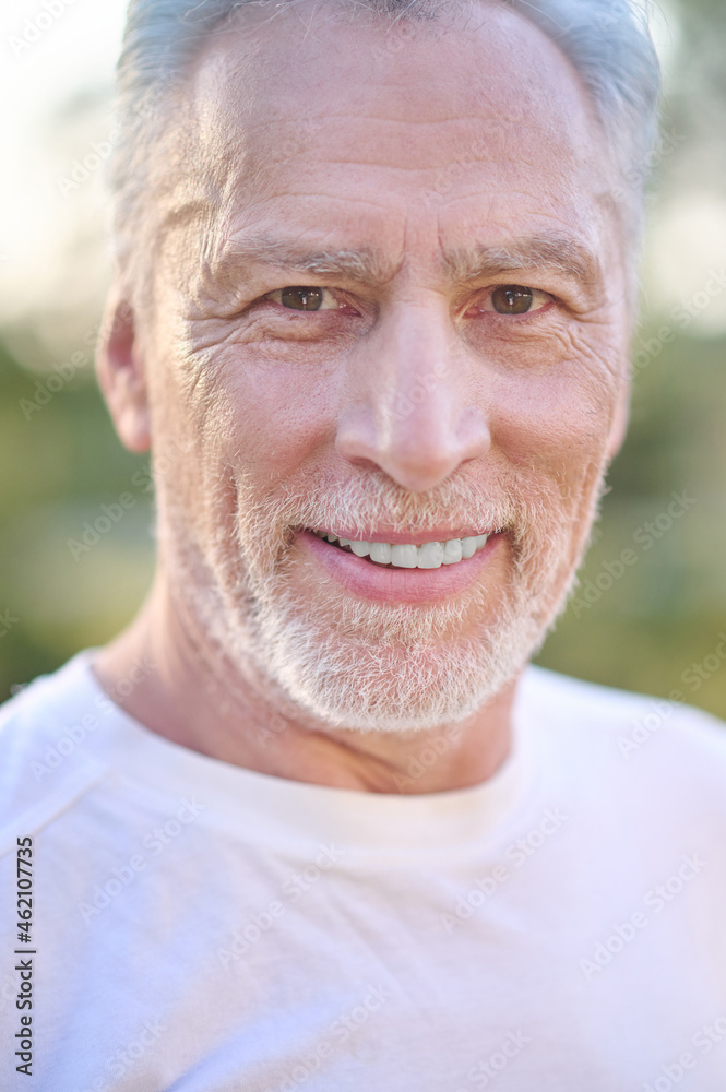A picture of a gray-haired man looking confident A picture of a gray-haired man looking confident