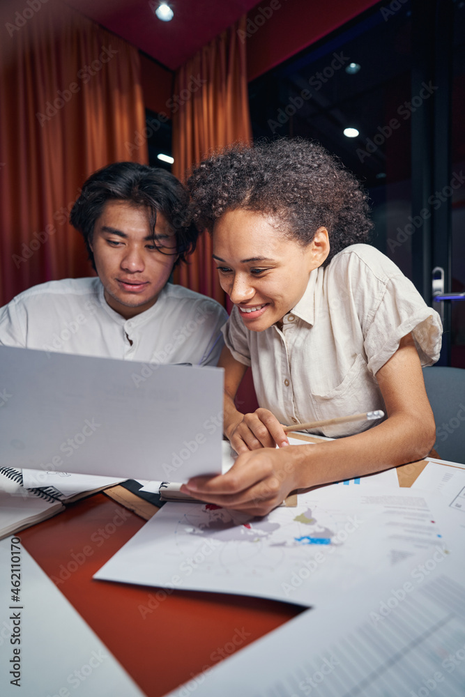 Male and female persons working together in office Male and female persons working together in office