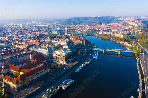 Aerial view of modern Prague cityscape overlooking bridges over Vltava river on sunny autumn day  Czech Republic