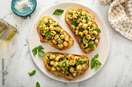 Healthy bruschetta with chickpea salad and herbs photo
