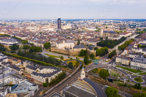 Drone view of ancient Chateau des ducs de Bretagne and Nantes Cathedral on background of downtown with modern skyscraper in summer  France..