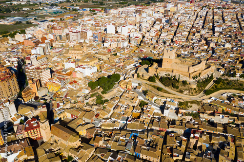 Scenic view from drone of historic center of Spanish city of Villena overlooking fortified Castle de Atalaya, Alicante.. photo