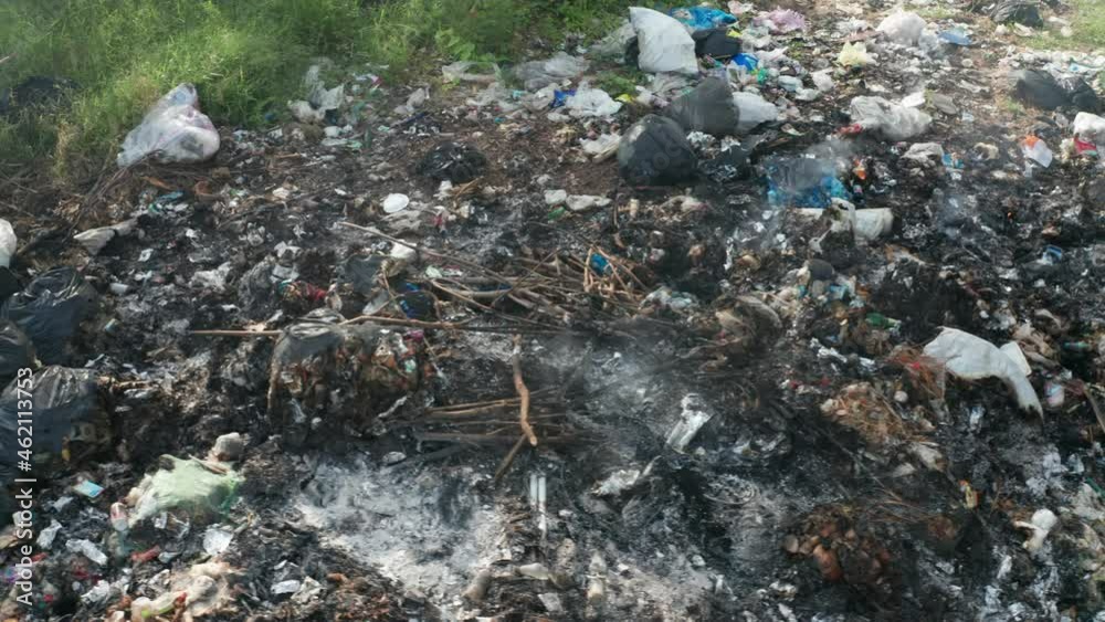 B roll of garbage dump in forest. Environment crisis. Garbage and fire burn. environmental damage and global warming. Toxic and Air pollution. Garbage dump in the middle of forest. Climate change. B roll of garbage dump in forest. Environment crisis. Garbage and fire burn. environmental damage and global warming. Toxic and Air pollution. Garbage dump in the middle of forest. Climate change.